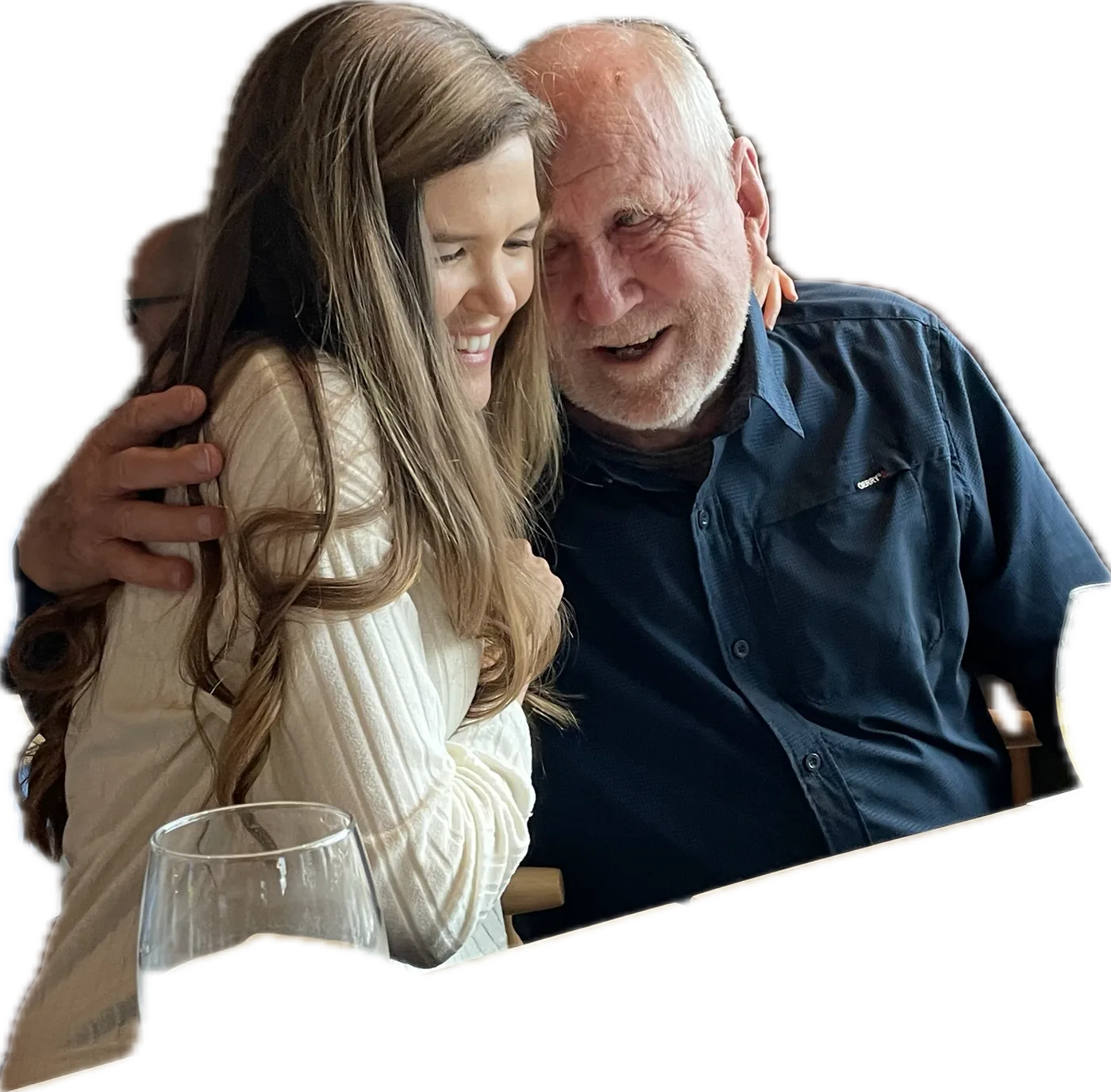 A grandfather and his granddaughter laughing together, heads touching