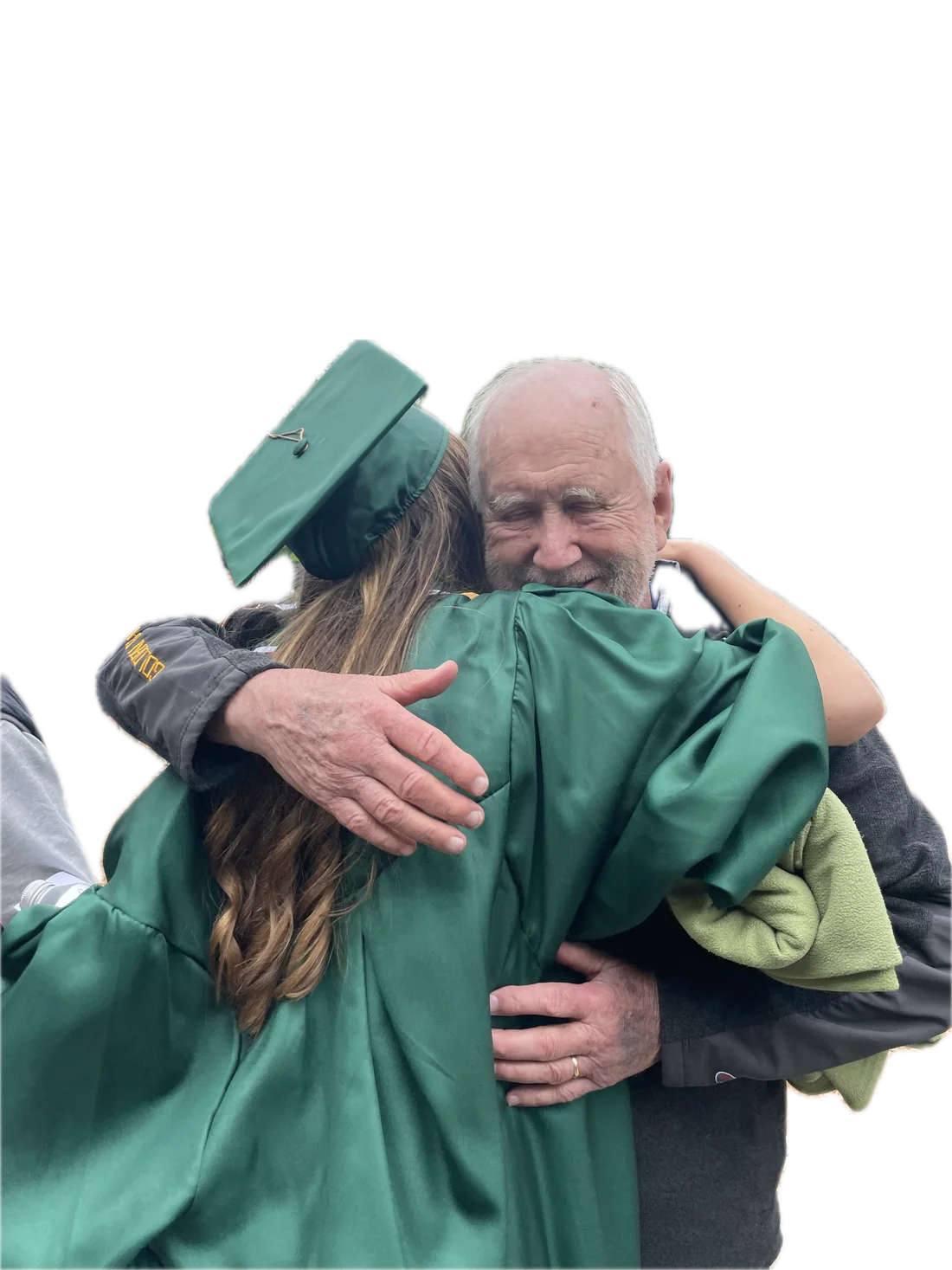 Bob hugging Megan, who is in her green graduation cap and gown